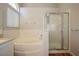 Bathroom featuring a large tub, glass-enclosed shower, and tile surround at 3416 Steppe St, North Las Vegas, NV 89032