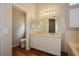 Bathroom with double sink vanity, large mirror with lighting, and separate toilet room at 3416 Steppe St, North Las Vegas, NV 89032