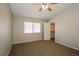 Neutral bedroom featuring a ceiling fan, window with blinds, and a closet with an open door at 3416 Steppe St, North Las Vegas, NV 89032