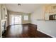 Open-concept living room with dark wood floors and sliding door to the outside at 3416 Steppe St, North Las Vegas, NV 89032