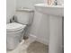 Modern bathroom features a pedestal sink and commode at 3517 Arcadian King Ave, Las Vegas, NV 89106