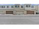 Exterior view of modern townhomes with private garage parking and manicured landscaping at 3517 Arcadian King Ave, Las Vegas, NV 89106