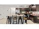 Kitchen features granite countertops, stainless steel appliances, and a large kitchen island with barstool seating at 3517 Arcadian King Ave, Las Vegas, NV 89106