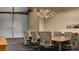 Spacious conference room with modern light fixture and seating for eight people at 3722 Las Vegas Blvd # 809, Las Vegas, NV 89158