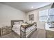 Comfortable bedroom with a large window and neutral decor at 4145 Nopal Serrano Ave, Las Vegas, NV 89141