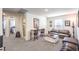 This loft features neutral carpet, a stylish coffee table, and a cozy leather couch at 4145 Nopal Serrano Ave, Las Vegas, NV 89141