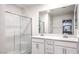 Bright bathroom with double sinks, and glass-enclosed shower at 4145 Nopal Serrano Ave, Las Vegas, NV 89141