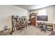 Comfortable home office space features a modern desk and chair, bookshelves, and natural light at 4145 Nopal Serrano Ave, Las Vegas, NV 89141