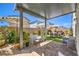 Relaxing covered patio featuring an outdoor seating area with a stylish umbrella and brick flooring at 4145 Nopal Serrano Ave, Las Vegas, NV 89141
