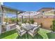 Outdoor patio seating area featuring umbrella, lush greenery, and a comfortable dining space at 4145 Nopal Serrano Ave, Las Vegas, NV 89141