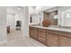 An open bathroom with double vanities, offering a spacious and bright area with contemporary fixtures at 4153 Solace St, Las Vegas, NV 89135