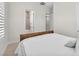 A bedroom featuring soft natural light, plush bedding, and easy access to the bathroom and walk-in closet at 4153 Solace St, Las Vegas, NV 89135