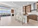 Open concept kitchen with an island, stainless steel appliances, and access to a balcony at 4153 Solace St, Las Vegas, NV 89135