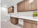 Well-lit laundry room features ample cabinet space, solid surface countertops, and a stainless steel faucet at 4153 Solace St, Las Vegas, NV 89135