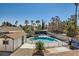 Private backyard with a pool, landscaping, and a cabana area, ideal for outdoor entertaining at 4302 Newhaven Dr, Las Vegas, NV 89147