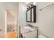 Bathroom vanity featuring marble countertops, a dark wood medicine cabinet, modern lighting, and neutral walls at 4302 Newhaven Dr, Las Vegas, NV 89147