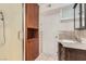 Bathroom with updated fixtures, glass enclosed shower, built in storage cabinet, granite counters, and ceramic tile at 4302 Newhaven Dr, Las Vegas, NV 89147