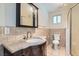Bathroom features granite countertop, dark wood vanity, walk in shower with glass door, tile backsplash, and updated fixtures at 4302 Newhaven Dr, Las Vegas, NV 89147