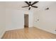 Bedroom with light hardwood floors, neutral paint color, ceiling fan, and a door to another room or closet at 4302 Newhaven Dr, Las Vegas, NV 89147
