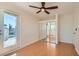 Bright bedroom with wood floors, access to a balcony, ceiling fan, and a mirrored closet at 4302 Newhaven Dr, Las Vegas, NV 89147