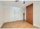 Bedroom with large sliding door closet and built in wood storage cabinets, neutral paint, and ceramic tile flooring at 4302 Newhaven Dr, Las Vegas, NV 89147