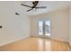 This bedroom has light hardwood floors, a ceiling fan, a neutral paint color, and access to a balcony at 4302 Newhaven Dr, Las Vegas, NV 89147