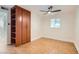 This bedroom features neutral walls, a ceiling fan, a window, and built in cabinets for plenty of storage at 4302 Newhaven Dr, Las Vegas, NV 89147
