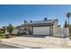 Charming single-story home with a well-maintained yard, solar panels, and a two-car garage at 4302 Newhaven Dr, Las Vegas, NV 89147