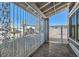 Covered front porch featuring decorative security gate, stone tile and manicured landscaping at 4302 Newhaven Dr, Las Vegas, NV 89147