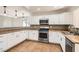 Updated kitchen with stainless steel appliances, ample counter space, and modern cabinetry ensures functionality at 4302 Newhaven Dr, Las Vegas, NV 89147
