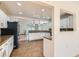 Open concept kitchen with stainless appliances and white cabinets offering seamless access to the living spaces at 4302 Newhaven Dr, Las Vegas, NV 89147