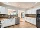 Modern kitchen features stainless steel appliances, white cabinets, and a pass-through to the dining area at 4302 Newhaven Dr, Las Vegas, NV 89147