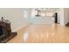 Spacious living room with fireplace, light hardwood floors, and open layout to the kitchen at 4302 Newhaven Dr, Las Vegas, NV 89147