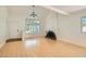 Inviting living room with hardwood floors, brick fireplace, and lots of natural light at 4302 Newhaven Dr, Las Vegas, NV 89147