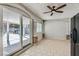 Bright sunroom featuring tile flooring, sliding glass doors to the patio, and a ceiling fan at 4302 Newhaven Dr, Las Vegas, NV 89147
