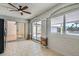 Bright sunroom featuring tile flooring, sliding glass doors to the patio, and a ceiling fan at 4302 Newhaven Dr, Las Vegas, NV 89147