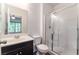 Bathroom with vanity sink, white cabinets, and walk-in shower featuring glass doors at 4650 Ranch House Rd # 86, North Las Vegas, NV 89031