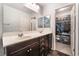 Bathroom features double sinks, a walk-in closet, and ample storage space in the dark wood cabinets at 4650 Ranch House Rd # 86, North Las Vegas, NV 89031