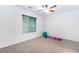 This bedroom features neutral paint, a ceiling fan, and a large window, perfect for a home gym at 4650 Ranch House Rd # 86, North Las Vegas, NV 89031
