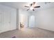 Bedroom with neutral paint and carpet, ceiling fan, and access to an ensuite bathroom at 4650 Ranch House Rd # 86, North Las Vegas, NV 89031