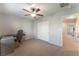 This bedroom offers neutral paint, a ceiling fan, a closet, and access to an ensuite bathroom at 4650 Ranch House Rd # 86, North Las Vegas, NV 89031