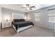 Comfortable bedroom with modern decor, a ceiling fan, and neutral carpet with dual lamps at 4650 Ranch House Rd # 86, North Las Vegas, NV 89031