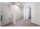 Bright hallway leading to a bedroom with neutral carpeting and freshly painted walls at 4650 Ranch House Rd # 86, North Las Vegas, NV 89031