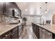 Modern kitchen with stainless steel appliances, granite counters, dark cabinetry and backsplash tiles at 4650 Ranch House Rd # 86, North Las Vegas, NV 89031