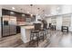 Modern kitchen with stainless steel appliances, a granite island, and stylish dark wood cabinetry at 4650 Ranch House Rd # 86, North Las Vegas, NV 89031