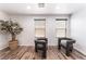 Cozy sitting area featuring modern chairs, wood flooring, and natural light from two windows at 4650 Ranch House Rd # 86, North Las Vegas, NV 89031