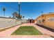 The backyard features a small patch of turf, brick patio, and a shed at 513 Berry Cir, Las Vegas, NV 89107
