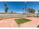 Spacious backyard with brick patio, small patch of turf, and a block wall fence at 513 Berry Cir, Las Vegas, NV 89107