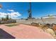 Spacious backyard featuring brick paver patio, patch of turf, and block fencing at 513 Berry Cir, Las Vegas, NV 89107