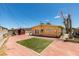 Backyard with turf, brick patio, detached shed, and access to the home's rear entrance at 513 Berry Cir, Las Vegas, NV 89107